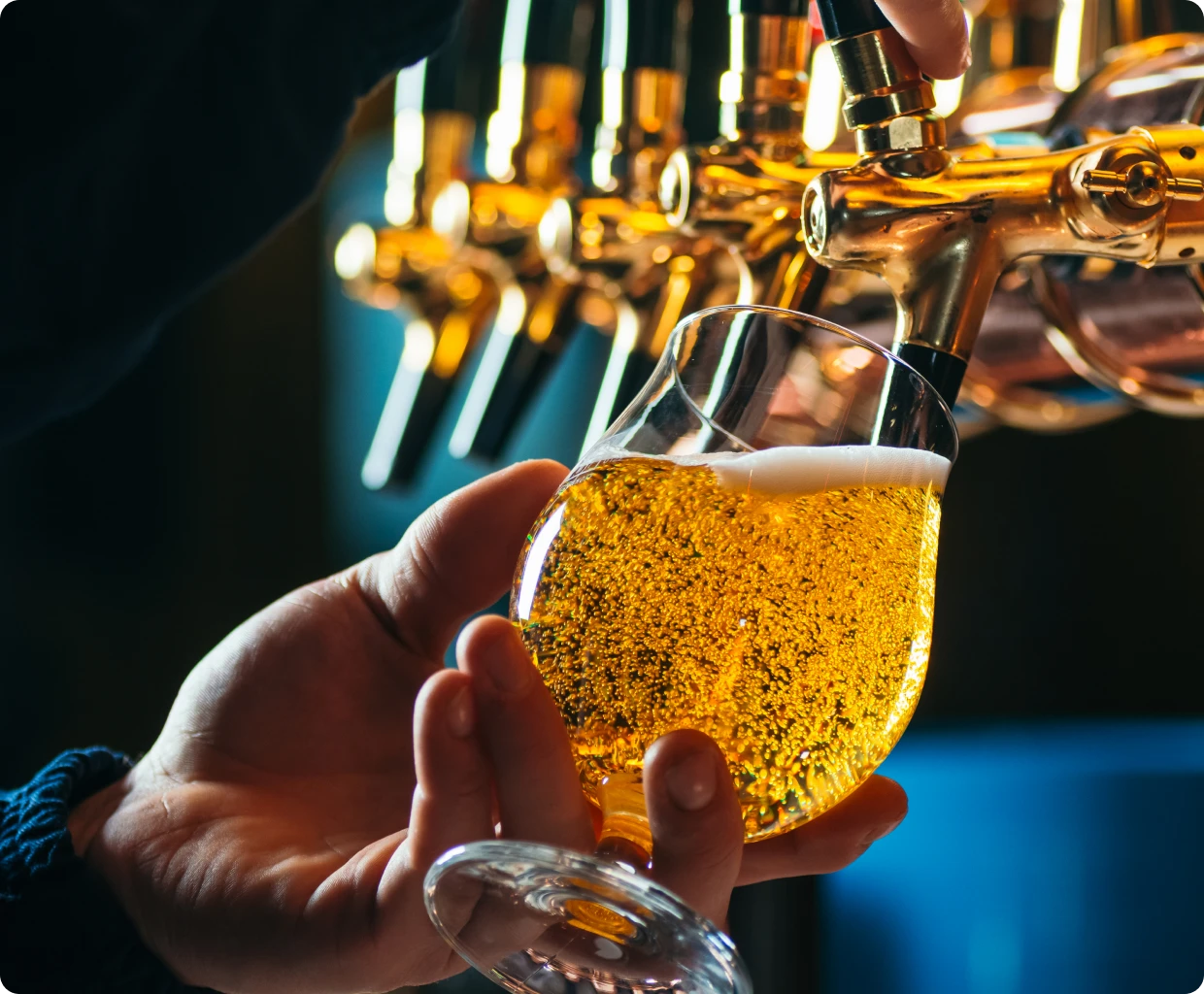 Pouring beer from tap into glass.